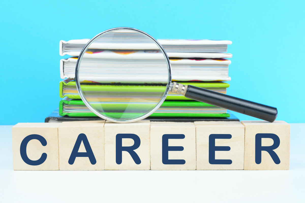 Career text on wooden blocks with book stack in the background. © Getty Images / jayk7