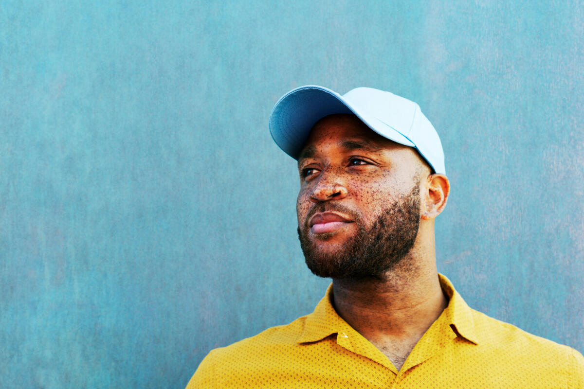 Man in baseball cap looking off camera © Tim Robberts / Getty Images