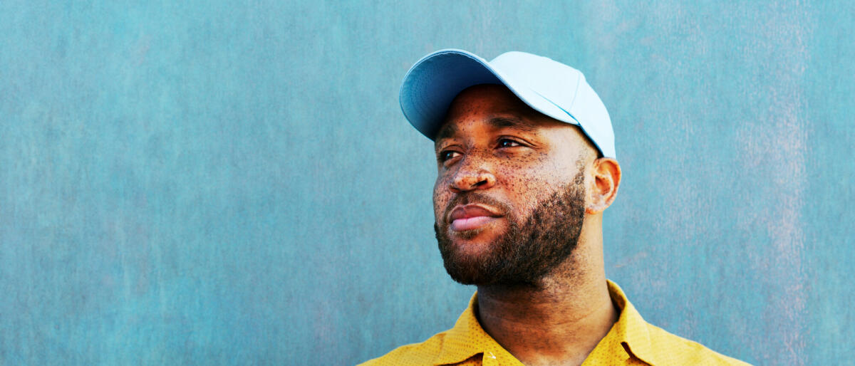 Man in baseball cap looking off camera © Tim Robberts / Getty Images