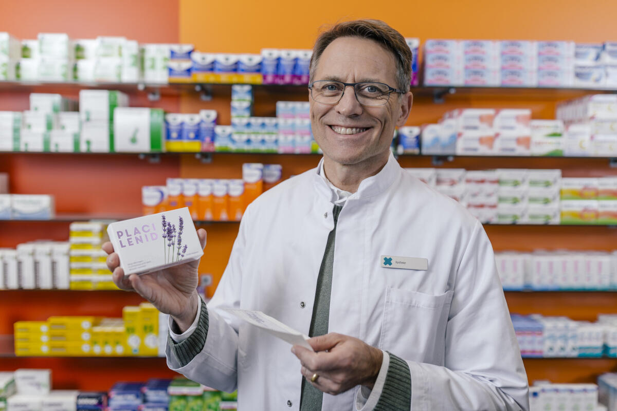 Porträt einer lächelnden Apothekerin mit Tablettenpackung und Rezept in einer Apotheke © Westend61 / Getty Images