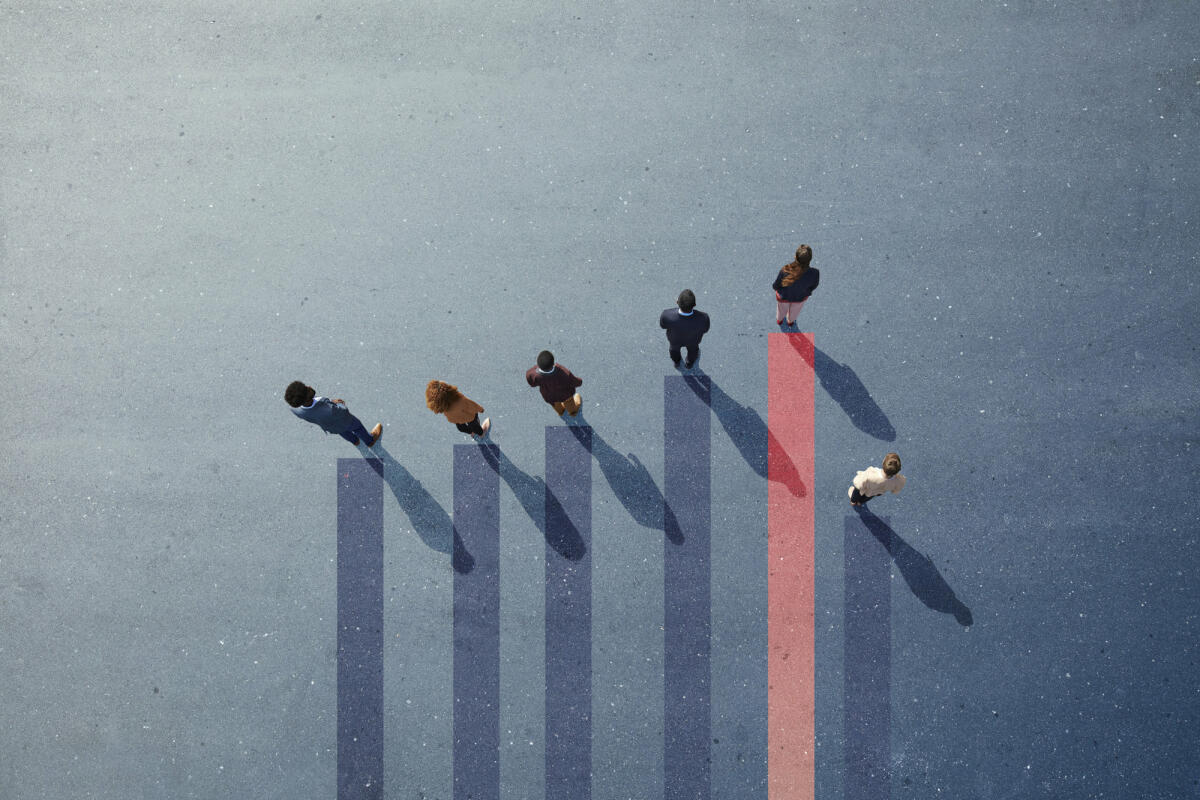 Group of young adults, photographed from above, on various painted tarmac surface, at sunrise. © Klaus Vedfelt / getty images