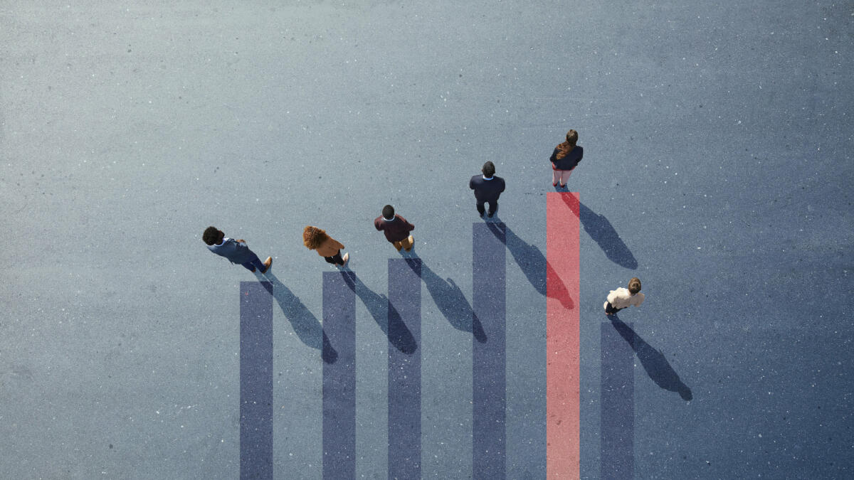 Group of young adults, photographed from above, on various painted tarmac surface, at sunrise. © Klaus Vedfelt / getty images