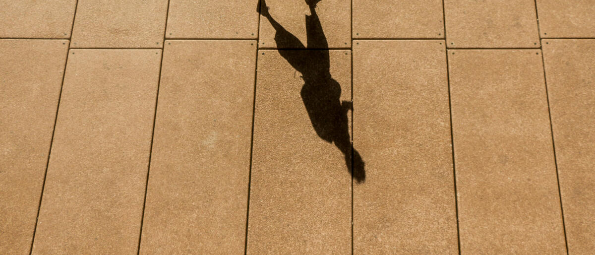 A High Angle View of a Long Shadow of a Person Walking in Sydney City © Felix Cesare / Getty Images